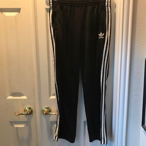 Men’s black Adidas athletic track pants with three stripes